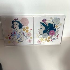 NWT. Disney Snow White is surrounded by flowers on this coaster set of 4